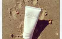 Image of Seams Hand Cream in the sand with handprint in the sand. Seams Hand cream image, seamsbeauty.co.uk