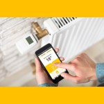 Hand sturning up the heat from a phone app Shutt